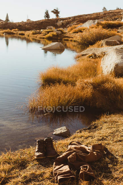 Hiking boots and jeans by lakeside, Mineral King, Sequoia National Park, California, USA — Stock Photo