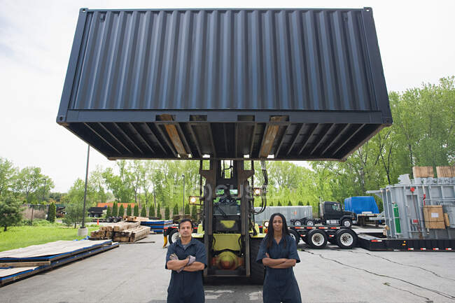 Colleagues by forklift truck — Stock Photo