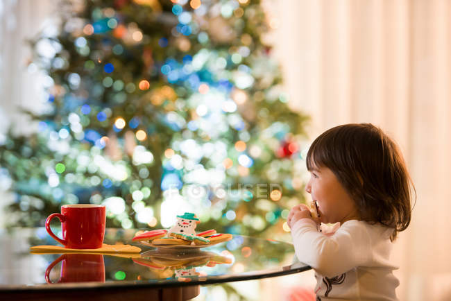 Girl eating Christmas cookies — Stock Photo