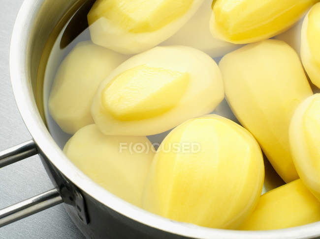 Potatoes boiling in saucepan — Stock Photo