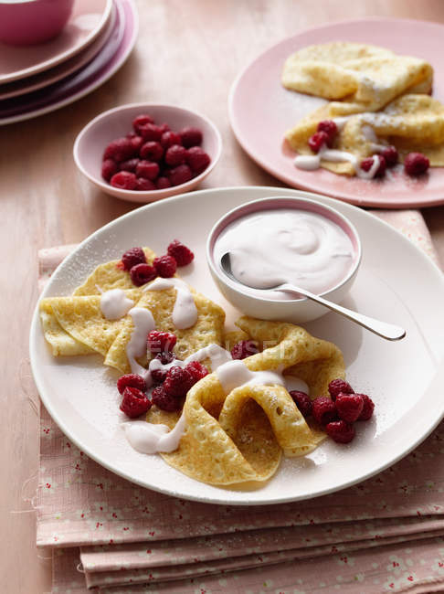 Plates of crepes with berries — Stock Photo