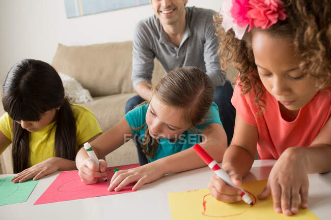 Three girls drawing pictures — Stock Photo