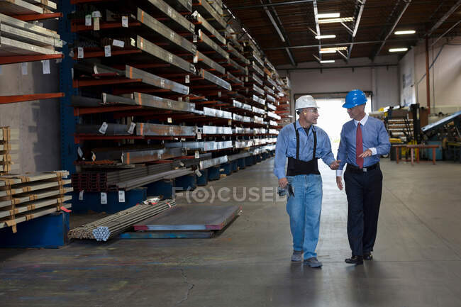 Trabalhador e empresário em fábrica de metal — Fotografia de Stock
