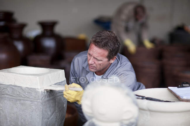 Painting and staining process in pottery factory — Stock Photo