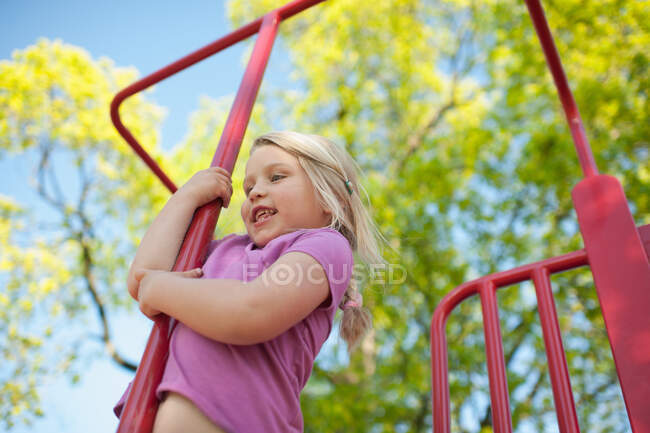 Chica en marco de escalada - foto de stock