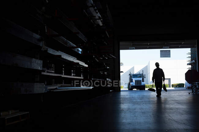 Silhouette of worker in metal plant — Stock Photo