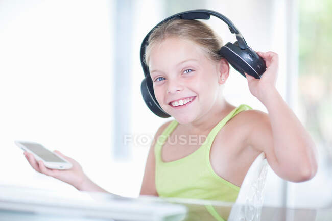 Menina ouvindo música em um smartphone — Fotografia de Stock