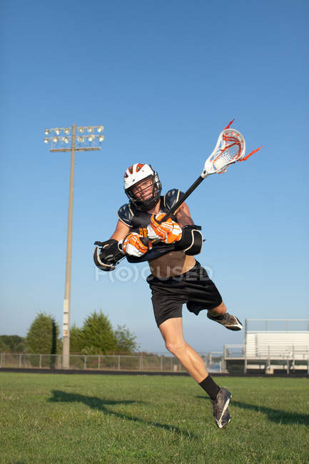 Junger Mann spielt Lacrosse — Stockfoto