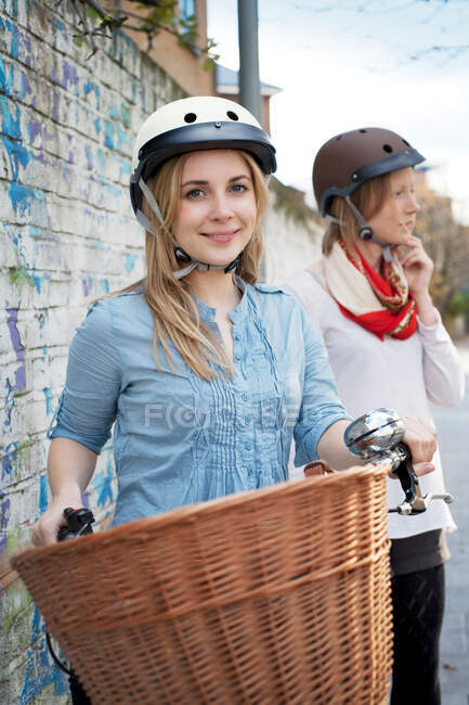 Woman on bicycle on city street — Stock Photo