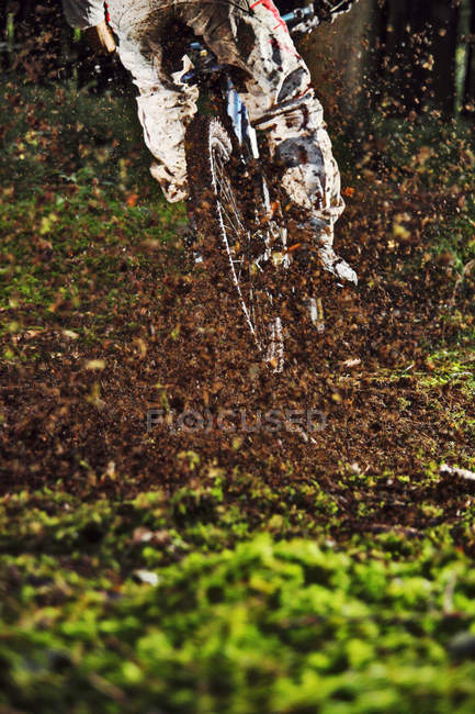 Cropped shot mountain biker on muddy track — Stock Photo