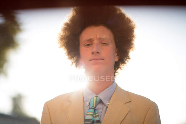 Portrait of teenage boy with red afro hair, wearing suit, outdoors — red  hair, individuality - Stock Photo | #171706600