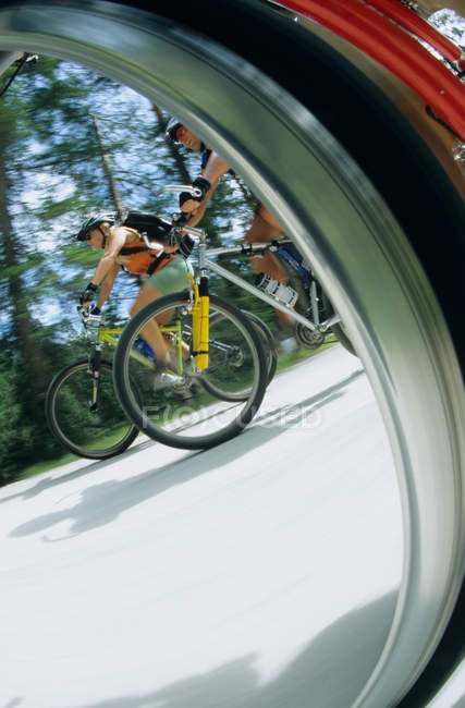Reflection of People cycling — Stock Photo