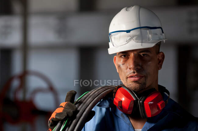 Промышленный рабочий с проводами на заводе — стоковое фото