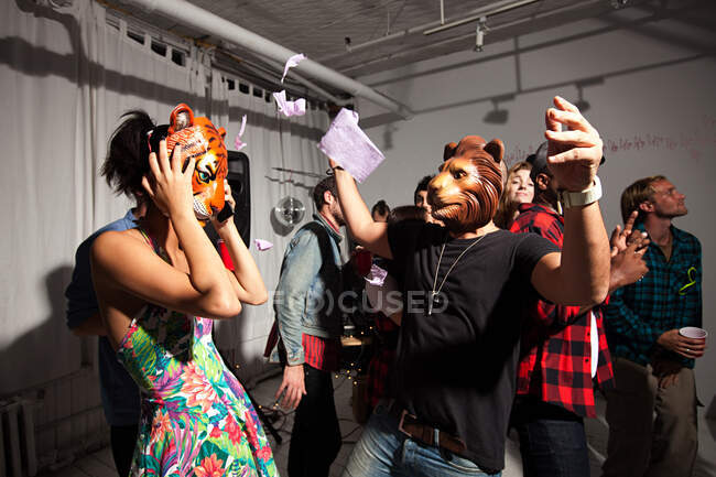Menschen mit Löwen- und Tigermasken tanzen auf Party — Stockfoto