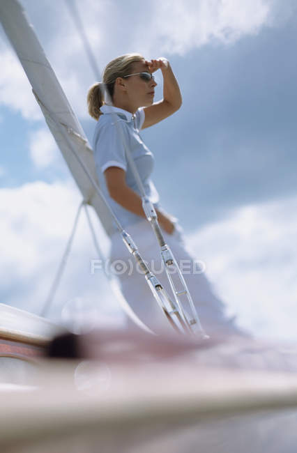 Woman on boat looking out to sea — Stock Photo