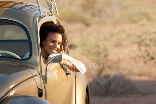 Young woman sitting in car, portrait — Stock Photo