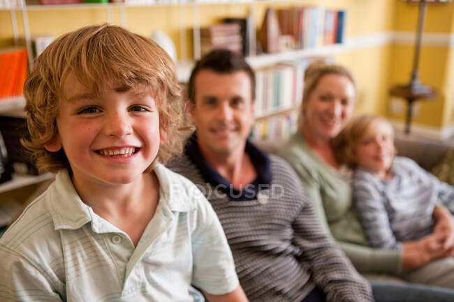 Family relaxing together in their living room — Stock Photo
