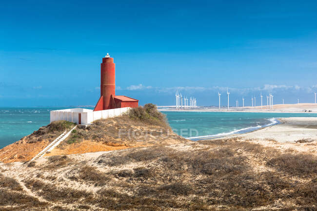 Beach lighthouse and distant wind farm, Fortim, Ceara, Brazil — Stock Photo