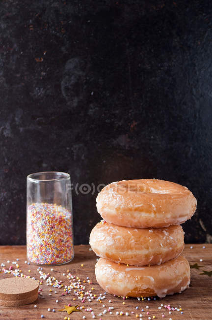 Glazed donuts and sprinkles — Stock Photo