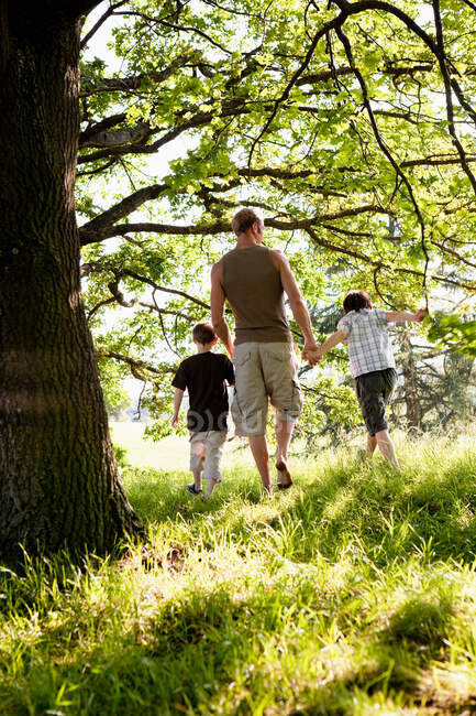 Padre e figli che camminano nel bosco — Foto stock