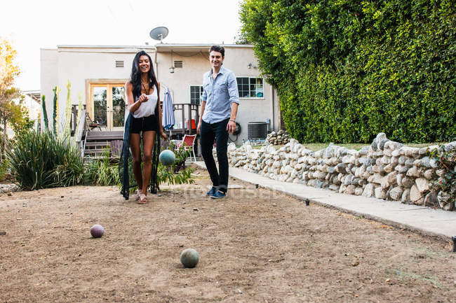 Young couple outdoors, playing boule — Stock Photo
