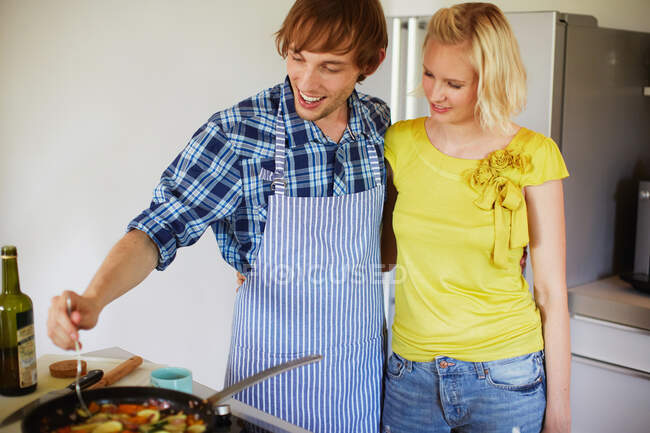 Couple cooking together in kitchen — Stock Photo