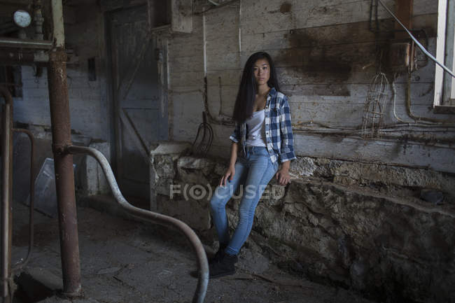 Portrait of pretty female teen in old barn — Stock Photo
