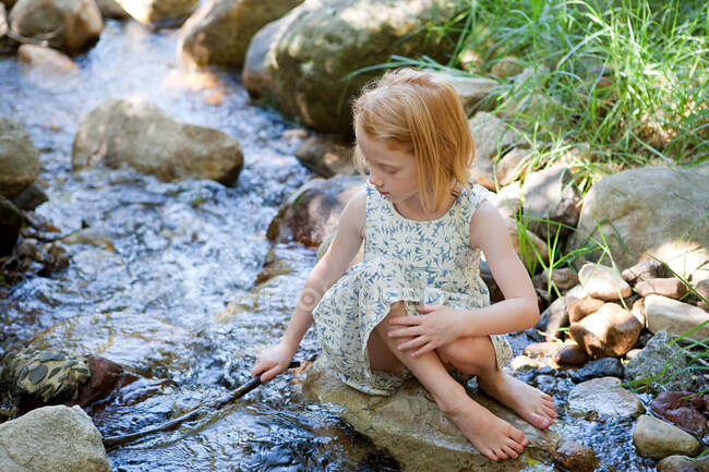 Girl playing in river — Stock Photo