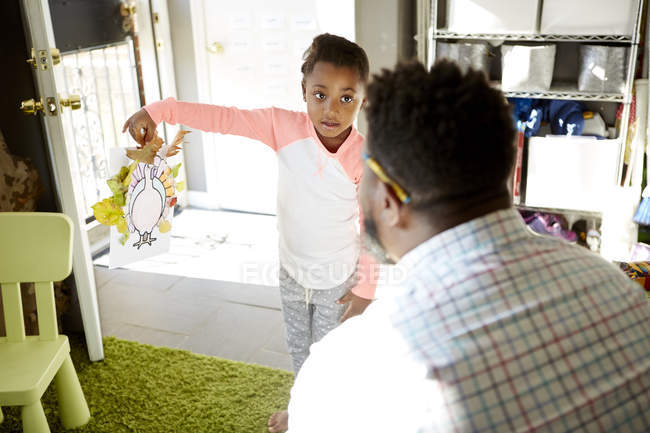 Daughter showing result of handicraft activity to father — Stock Photo