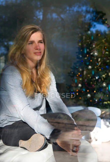 Teen girl looks thinking at christmas — Stock Photo
