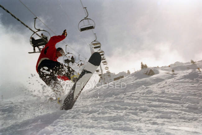 Male in action on a snowboard — Stock Photo