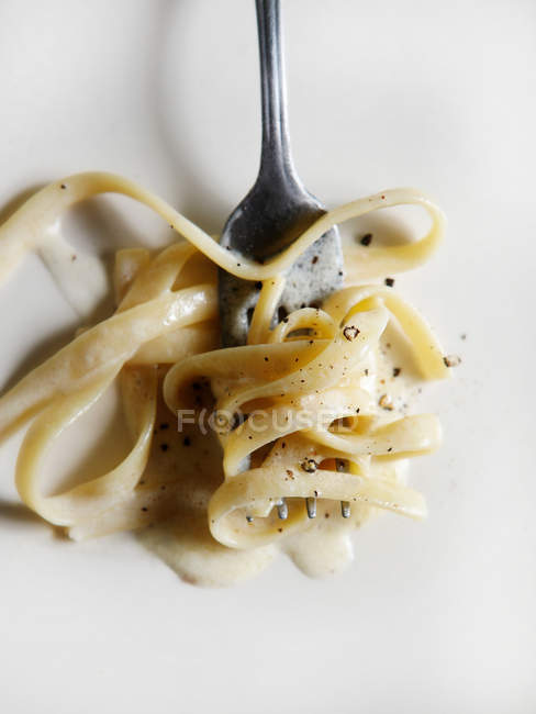Close up of lettuccine pasta on fork — Stock Photo