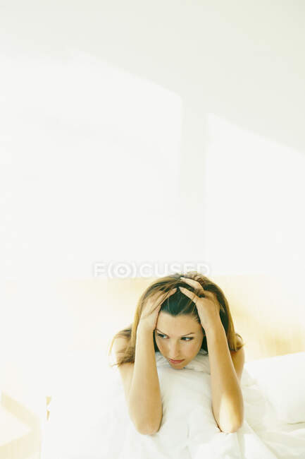 Woman holding her head — Stock Photo