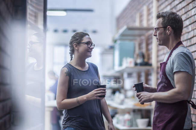 Cape Town, South Africa, two co workers discussing together in ceramic workshop — Stock Photo