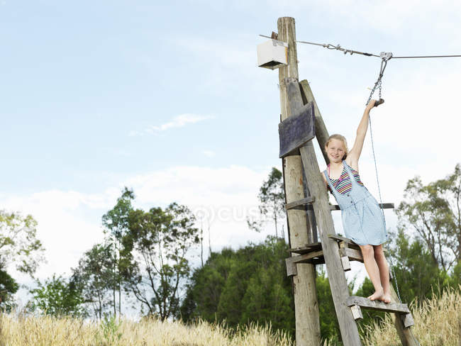 Girl ready to swing on rope slide — Stock Photo