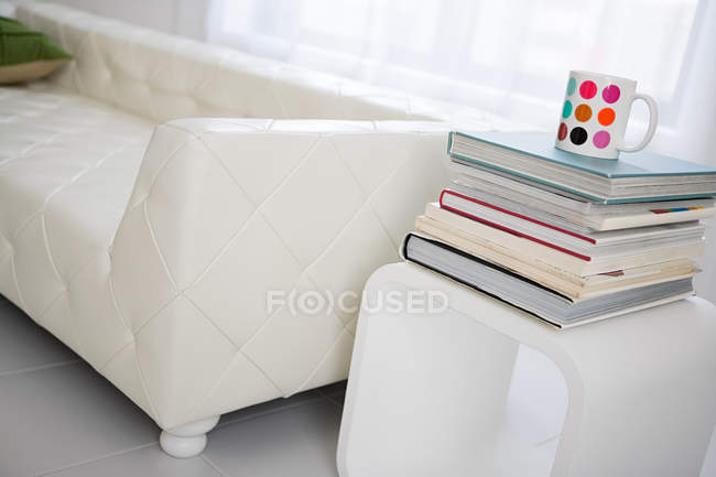 Sofa and a stack of books — Stock Photo