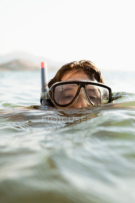 Woman wearing snorkel in water — Stock Photo