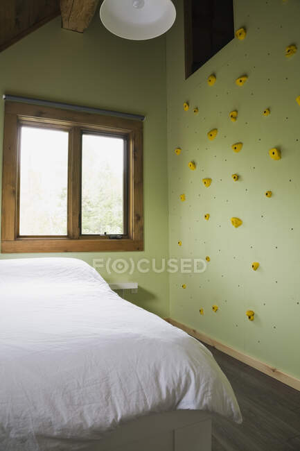 Детская спальня со стеной для скалолазания на верхнем этаже в бревенчатом доме, Квебек, Канада. Это изображение является собственностью освобожденной. CUPR0271 — стоковое фото