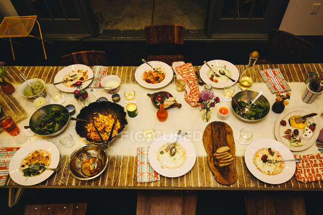 Dining table setting for six, with variety of dishes — Stock Photo