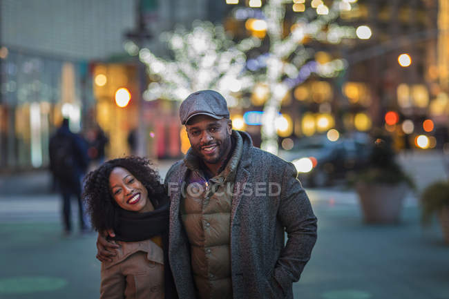 Portrait of romantic happy couple enjoying city during winter holidays — Stock Photo