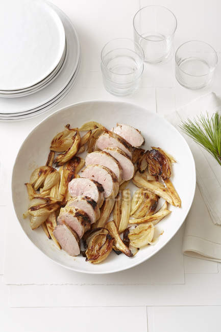 Still life of Pine Roasted Pork Tenderloin with Parsnips and Onions — Stock Photo