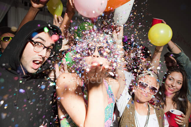 Woman blowing glitter at party — Stock Photo