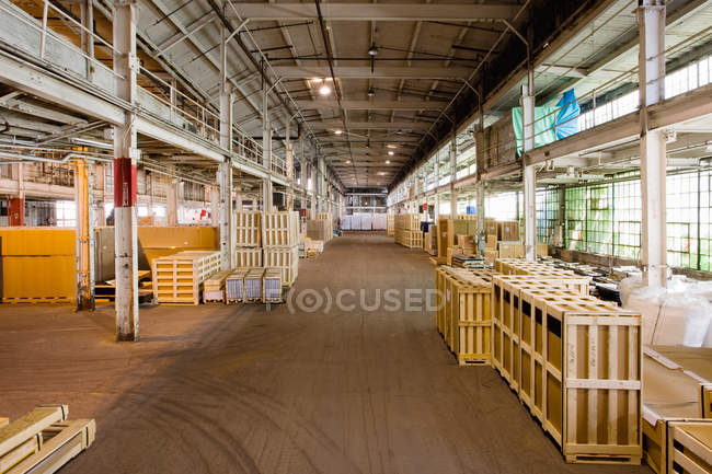 Empty pallets stacked in distribution warehouse — Stock Photo