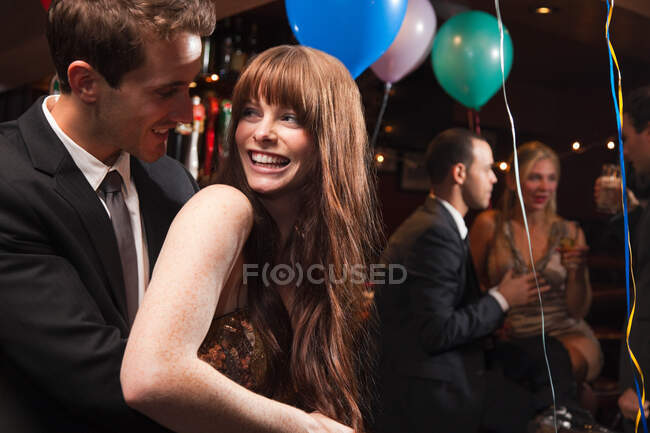 Happy young couple at party — Stock Photo