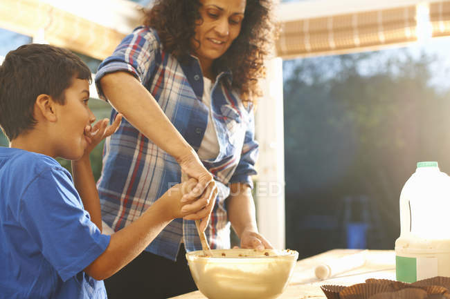 Mother and son baking in kitchen at home — Stock Photo