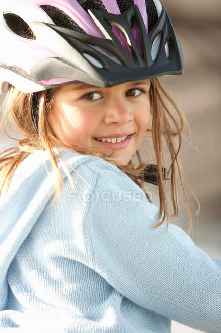 Girl wearing bike helmet outdoors — Stock Photo