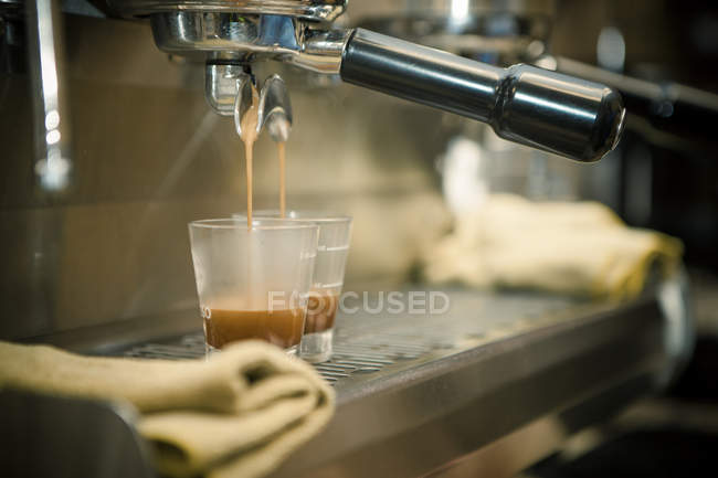 Close up of coffee machine pouring espresso in cafe — Stock Photo