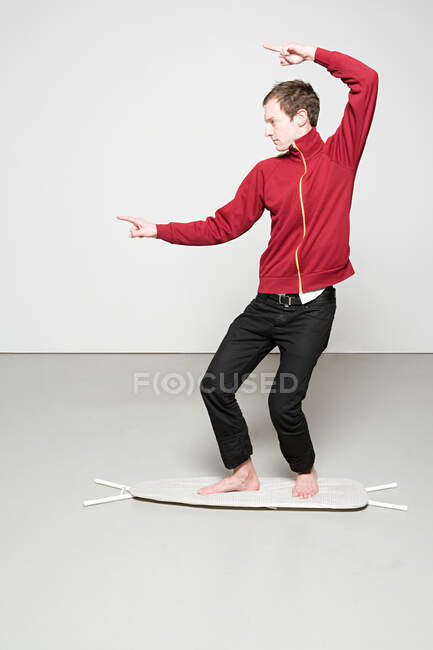 Man surfing on an ironing board — Stock Photo