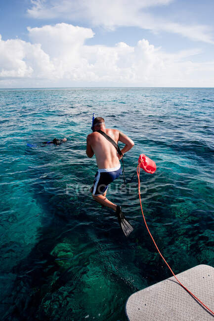 Rescue of diver by boat crew — Stock Photo