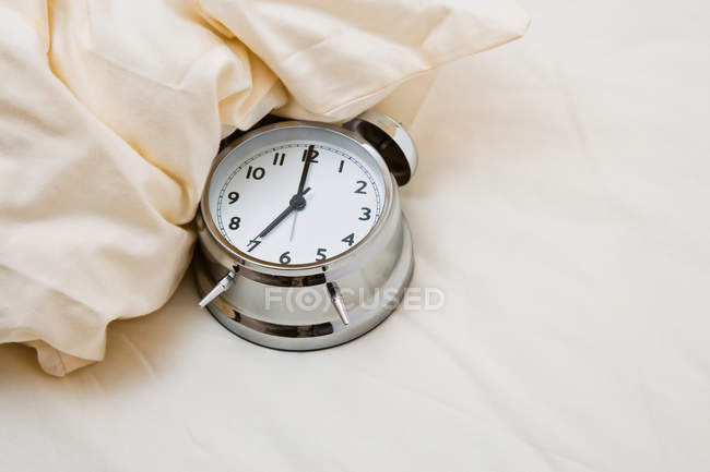 Close up of Alarm clock on bed — Stock Photo
